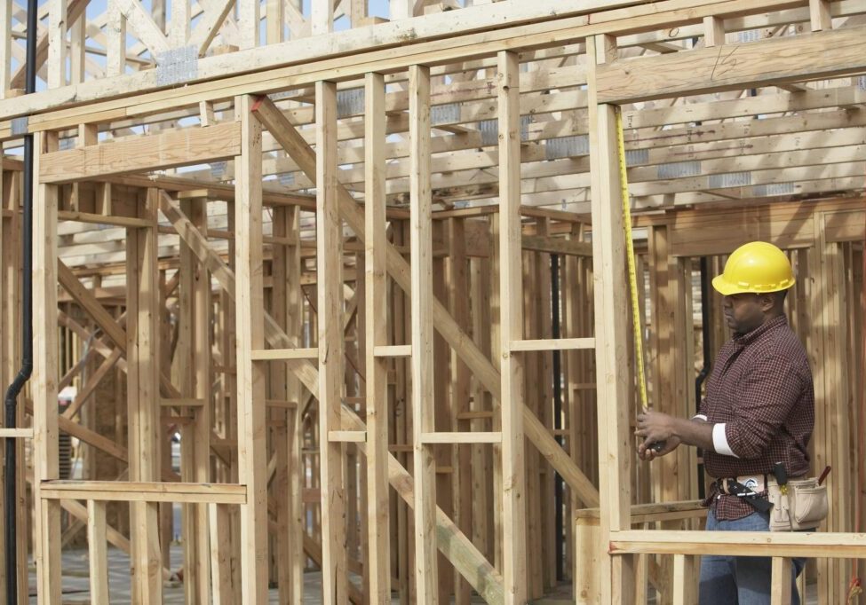 man measuring the wood