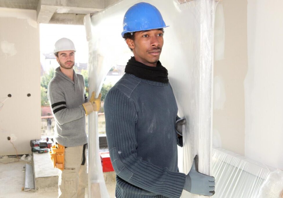 men transferring the glass