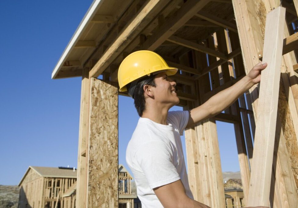 man holding a wood plank
